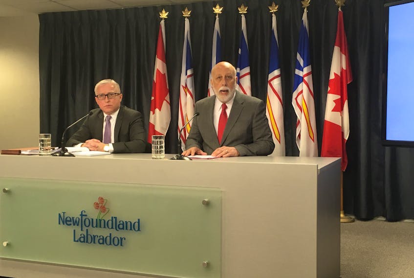 Advanced Education, Skills and Labour Minister Al Hawkins (right) takes questions on the province’s handling of minimum wage at the Confederation Building Media Centre Feb. 20. Hawkins was joined by Ken Clements, director of the labour standards division.