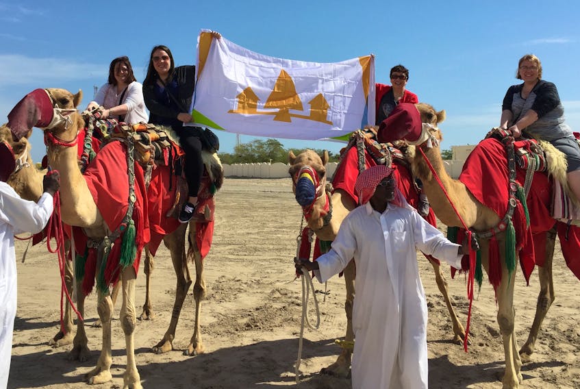 (From left to right) Tanya Fizzard, Crystal Ford, Joan Pynn and Angie Brown proudly display the Grand Falls-Windsor flag in the deserts of Qatar.