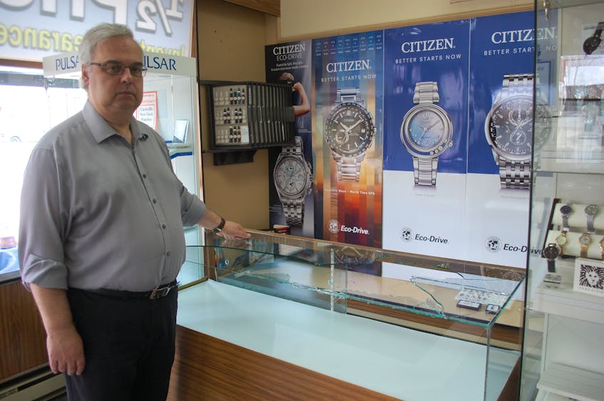 Lou Alteen, owner of Alteen’s Jewellers in Grand Falls-Windsor, stands next to a display case shattered by a burglar during the early morning hours of May 11.