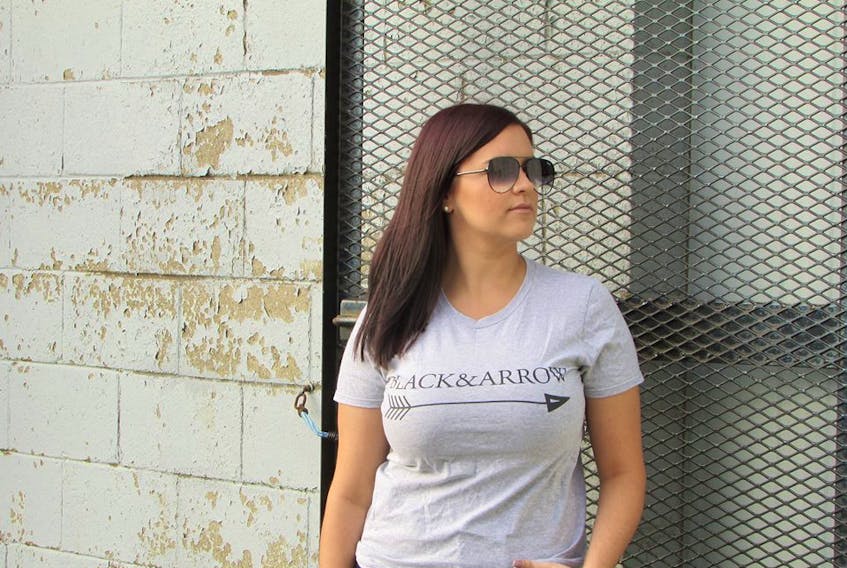 Melanie Cater is the owner of a new online boutique called Black and Arrow. Here she is modeling the shop’s signature T-shirt.