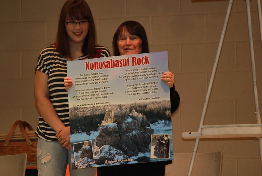 Ann Warr and her former Grade 2 student, Denkia Lewis, unveil the plaque that will honor Nonosabasut, Beothuk chief and hero.