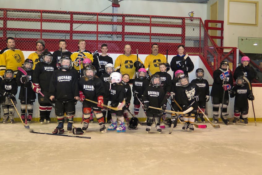 Following an hour of hockey, Buchans Minor Hockey players and the 35-and-over hockey team posed for a photo. It was the final big game of the season for the young boys and girls and they were excited to have the chance to beat the big guys.