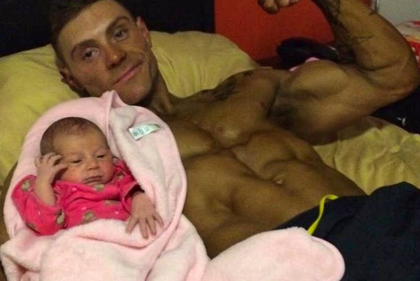 Josh Niquette relaxing with his days old daughter Rory.