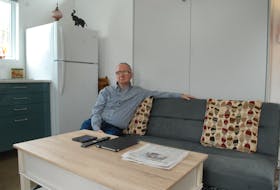 Art MacLeod sits in his recently constructed tiny house in Liverpool. He moved in Feb. 1.