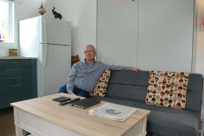 Art MacLeod sits in his recently constructed tiny house in Liverpool. He moved in Feb. 1.