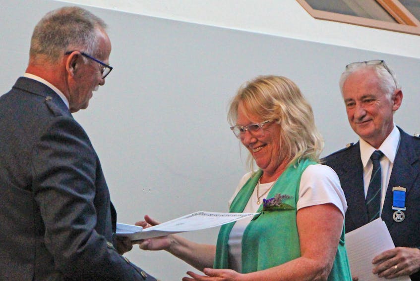 Beverley Gandy accepted induction on behalf of her husband, Bruce, during the Antigonish Highland Society Games’ Hall of Fame ceremony July 11 at the East Coast Credit Union Social Enterprise Centre. Antigonish Highland Society president Robert ‘Bunny’ Cochrane made the presentation, while Danny Gillis (back) read the citation. Corey LeBlanc