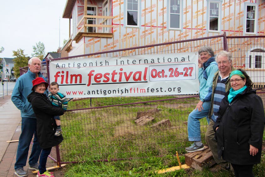 Antigonish International Film Festival (AIFF) organizing committee members Shaun Chisholm (left), Elaine MacLean, Leo MacLean, Trina Davenport, Don Davenport and Carole Roy with this year’s promotional banner.