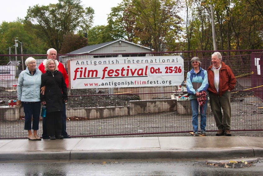 Antigonish International Film Festival organizing committee members Pam (left) and Shaun Chisholm, Elaine MacLean, and Trina and Don Davenport, hang the event’s promotional banner near the new Main and Hawthorne street intersection, Oct. 8. AIFF is in its 13th year.