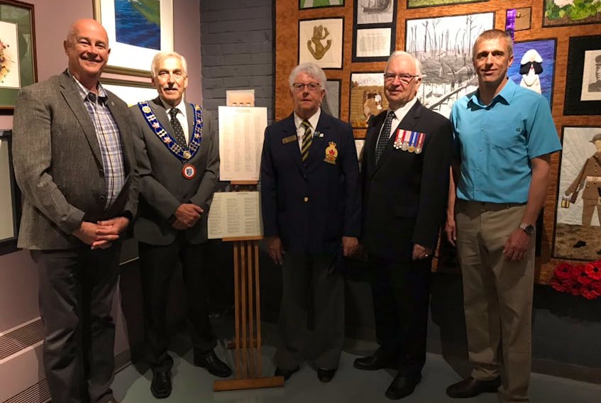Standing beside the plaques honouring World War veterans from the Bay Roberts area are Avalon MP Ken MacDonald, Mayor Philip Wood, Royal Canadian Legion member Eleanor Andrews, Bay Roberts Heritage Society president Eric Jerrett and Deputy Mayor Walter Yetman. Andrews is a descendant of Arthur Somerton, who served in the First World War.