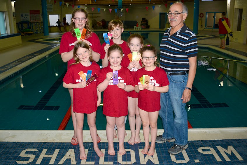 Standing with their coach Manson Gloade at the YMCA of Cumberland in Amherst, Spartan Swimmers display the ribbons they earned in Port Hawkesbury. The Spartans are: (front, from left) Ava Taggart, Chelsea Elliot, Gemma Leslie-Dowe, (back, from left) Aurelia Mitchell, Simon Buske, and Olivia Elliot.