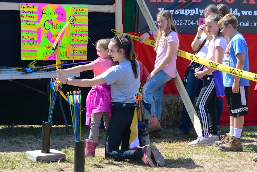Canada Games archer, Ashley Hamel, provided an archery lesson for seven-year-old Maria MacDonald at the 2019 Cumberland County Exhibition. Kids, and some adults, lined up for lessons on Aug. 28 and 30. Standing directly behind them is Maria’s 12-year-old sister Haylie MacDonald. The MacDonald’s are from Shinimacas.