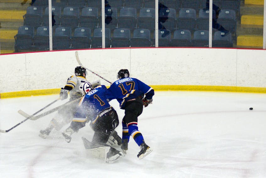 Trent Wilkie came a long way out of his net to poke-check the puck during third period action last Sunday in Springhill. Wilkie made 69 saves in the game, while the Blues managed 18 shots on the Antigonish Bulldogs net.