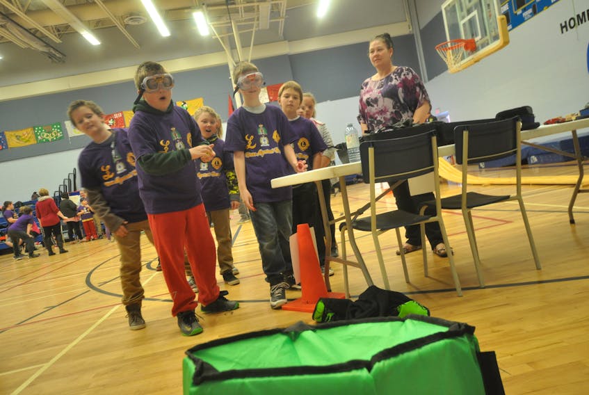 A little impairment gave Grade 5 students an idea of how difficult it can be to do some of the easiest tasks, like tossing coins into a container. The impairment goggles worn by participants imitate the visual effects of alcohol. 

Christopher Gooding/Amherst News