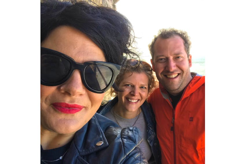 Columnist Emilie Chiasson with friends in Nazare, Portugal, where waves and love crashed together.
