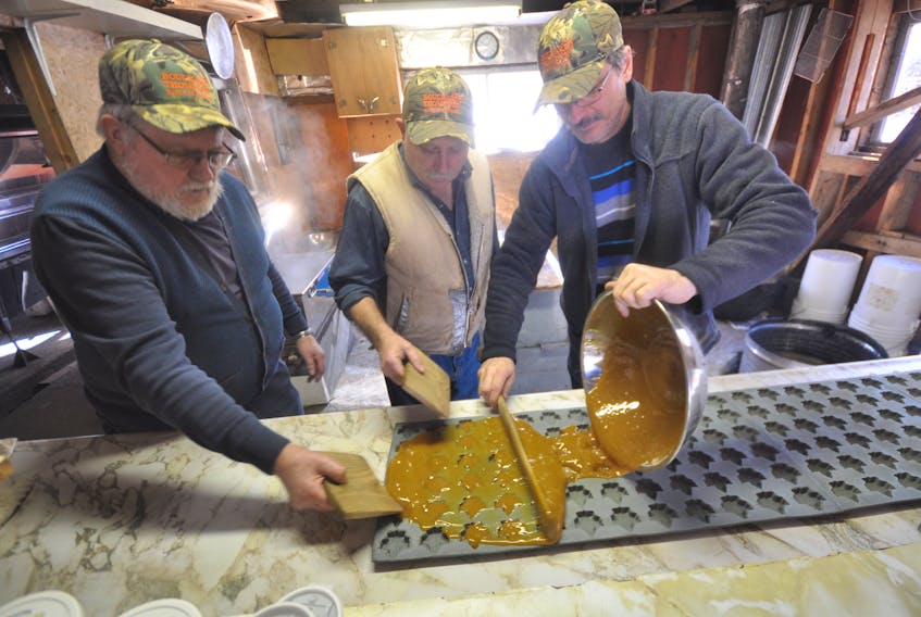 [From left] Stan Thompson, Keith Coates and Eric Bouchard use a combination of modern and traditional tools to make maple butter sweets.