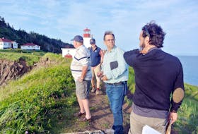 Provincial geologist John Calder and area municipal councilor Don Fletcher look out over the cliffs at Cape d’Or while UNESCO evaluators Nikolaos Zouros and Asier Hilario talk during their July 27 visit to the scenic tourist destination near Advocate Harbour.