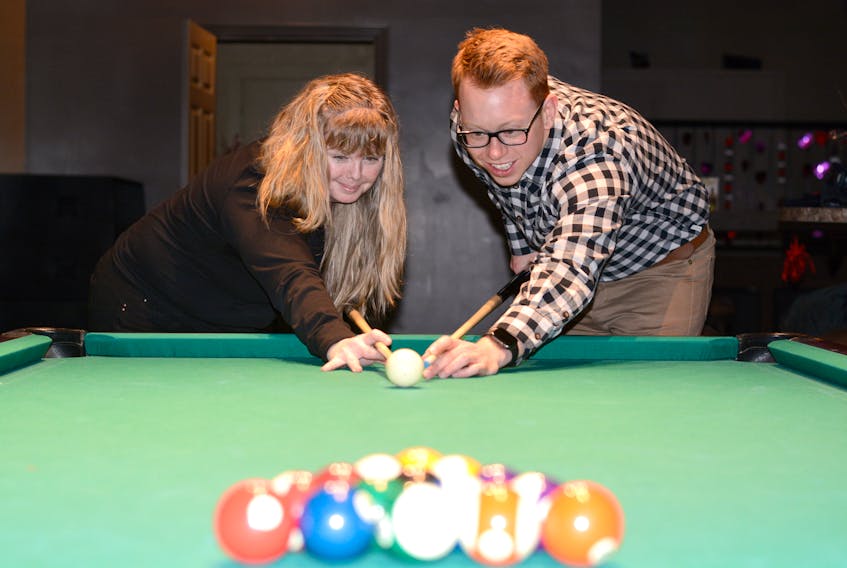 Lorraine Ramsay from Dooly’s and Cumberland YMCA manager of development Jeff MacNeil line up a shot in preparation for Cues for Kids on Feb. 23 at the downtown bar. Cue for Kids is a fundraiser for the YMCA’s Strong Kids Campaign.