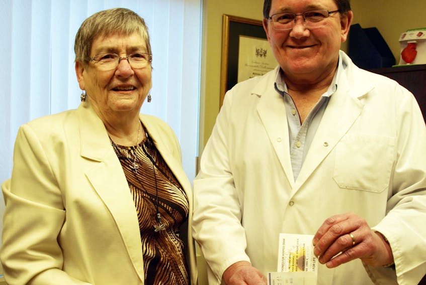 Gerry Helm of the Cumberland County Hospice & Palliative Care Society sells the first ticket in the society’s Toonies for Hospice draw to Amherst physician Dr. Brian Ferguson. The weekly Toonie draw begins May 2 with all the proceeds going to build and support a free-standing hospice facility.