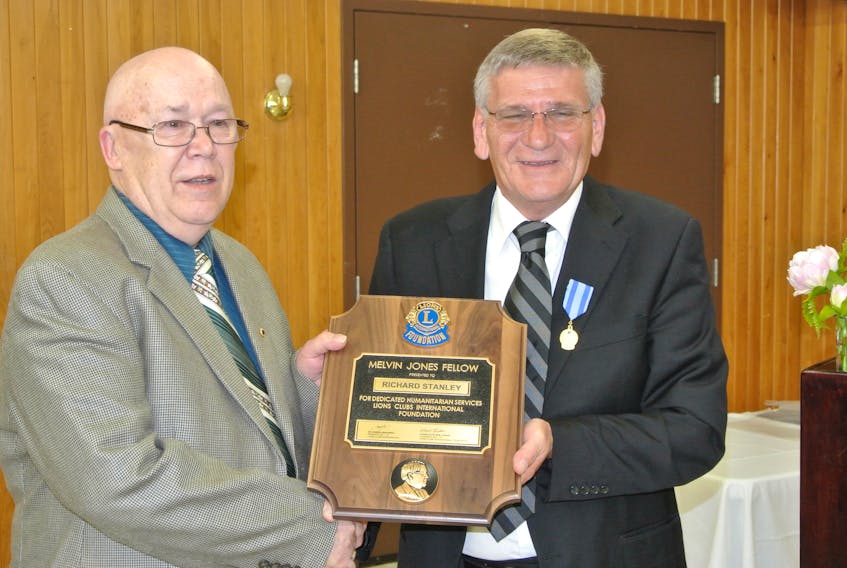 Richard Stanley (left) is presented a Melvin Jones Fellow by Amherst Lions Club president Steve Butler. The award, the highest in Lionism, is presented for dedicated humanitarian services and is named for the founder of Lions.