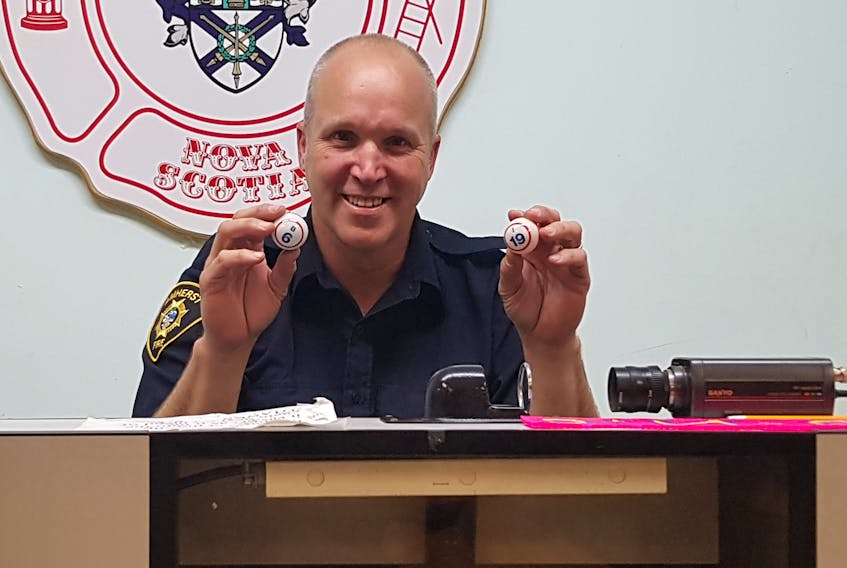 Amherst fire fighters association member Kurt Fawthrop holds up a pair of bingo balls. The association is moving its weekly bingo to Tuesdays beginning June 19.