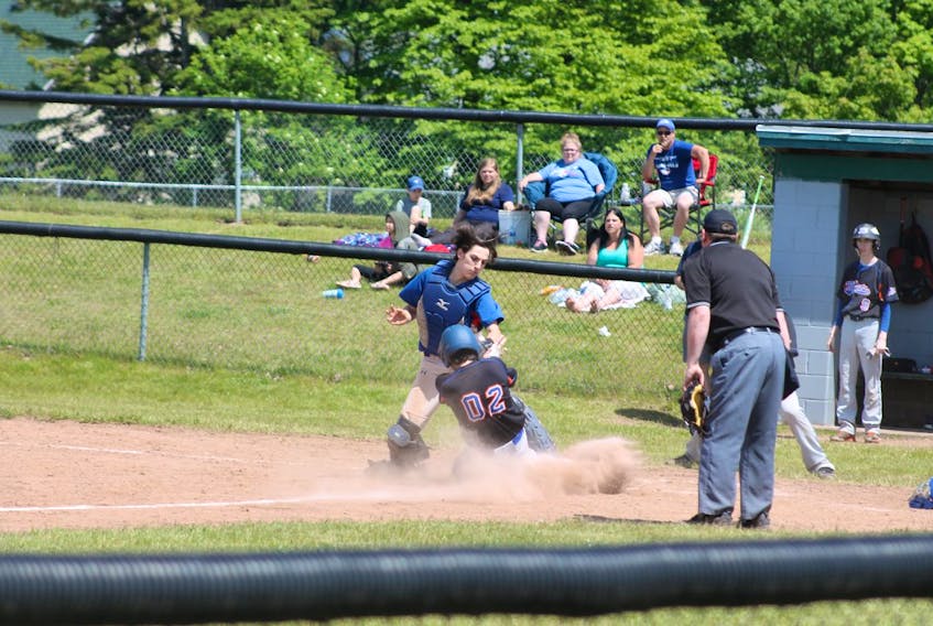 Amherst Athletics catcher Riley Girouard attempts to put the tag on a Halifax Mets’ baserunner in Bluenose Midget AA League action at the Robb Centennial Complex on Sunday.