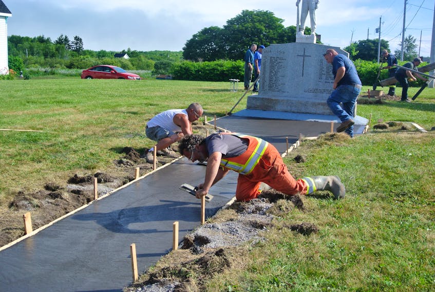 Crews from Gray Concrete Foundations of Amherst work on a new walkway leading up to the cenotaph in Joggins. The cenotaph is being fixed up prior to a ceremony later this year that will see the names of 10 First World War veterans added to the monument.