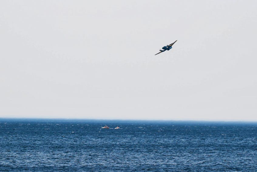 A plane circles a pair of boats in the Northumberland Strait on Wednesday evening. A couple ran into problems when their small boat began drifting further from shore because of strong offshore winds. They were rescued from the strait by a boat from the Tidnish Bridge Fire Department. - Photo courtesy of Mike Hunter.