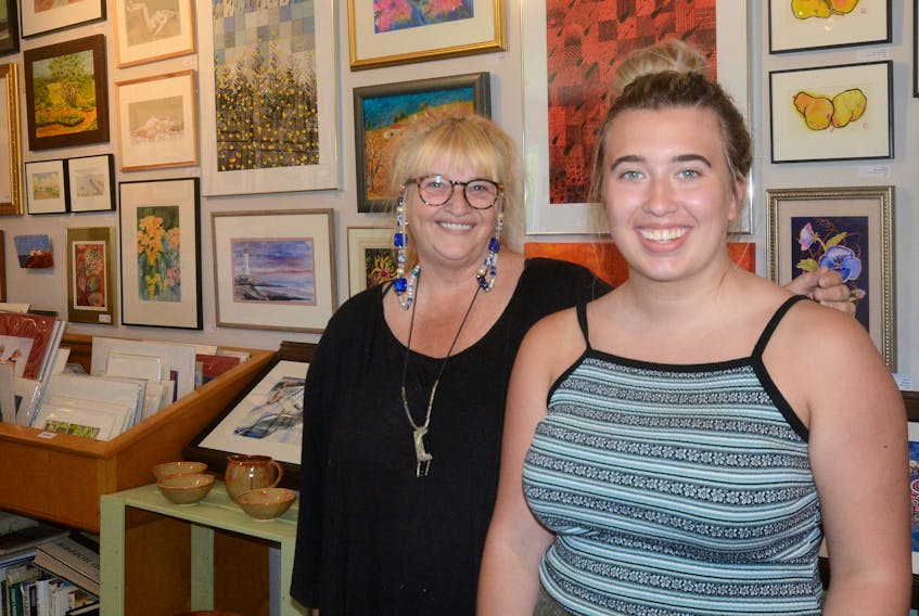 Diana Vertis McIsaac, left, and Farah Moreau will greet art aficionados all summer at the Tidnish Bridge Art Gallery. McIsaac is a featured artist at the gallery, and Moreau will study art at NSCAD University in Halifax in September. Moreau is a 2018 graduate of Amherst Regional High School who has been hired to work at the gallery for the summer.