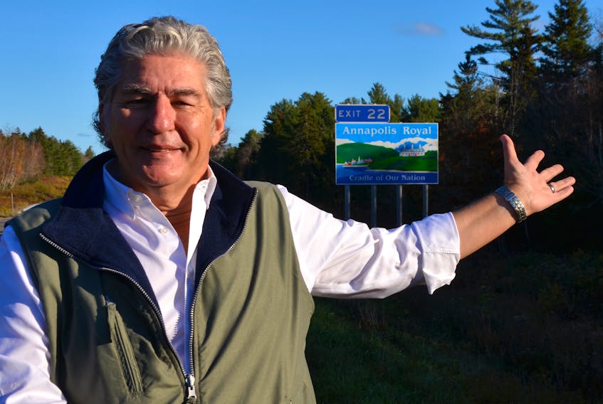 Annapolis Royal Mayor Bill MacDonald gestures towards a new Highway 101 sign that points to Annapolis Royal at Exit 22. The new sign proclaims the town as the ‘Cradle of Our Nation.’