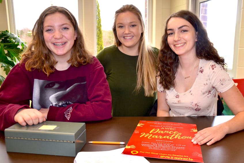 Grace Law, left, and Mikayla Chute, right, were helping Gemma Tompkins, centre, sell tickets to the second annual AWEC Dance Marathon that’s set for May 11 at the school. The Grade 9 students said sales were going well. Gemma, in Grade 12, is president of the students council that is organizing the event.