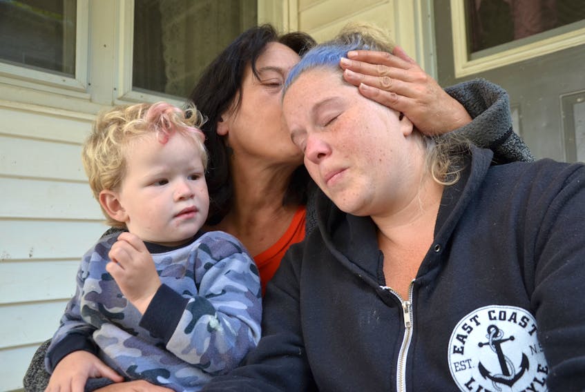 Tammy Connell holds her daughter Rose on the steps of a small home in Middleton where they learned of the fatal injuries Rose’s boyfriend Allison Mahar sustained during an incident in New Glasgow early in the morning of Sept. 7. Allison died late that day. Rose said it’s not fair young Lincoln will grow up not knowing his step-dad.