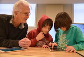 Geoff Keymer works with a couple of youngsters at the Innovation Lab at the Community Hub in Annapolis Royal. The hub houses the library, the lab, and a music room at The Academy. The hub’s grand opening is Feb. 15 at 11 a.m.