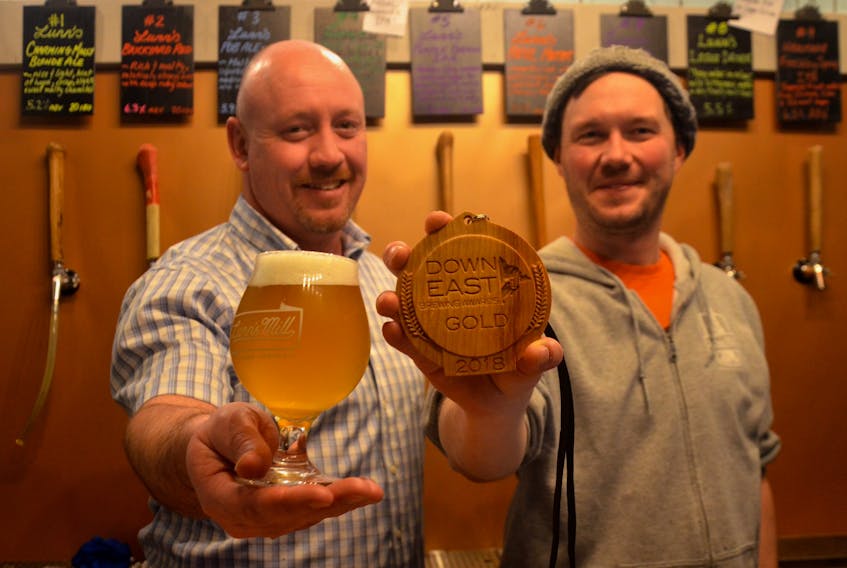 Lunn’s Mill Beer Company in Lawrencetown picked up a gold medal at the 2018 Down East Brewing Awards for its IPA First Cut. Chad Graves holds out the winning IPA while Sean Ebert shows the award. The two are Lunn’s Mill partners along with Mark Reid and Chantelle Webb.