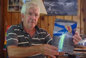 Valley author Dave Whitman is shown with his new book 'Moving to Nova Scotia,' which chronicles the stories of people from other parts of Canada and the world and why they settled in the province.