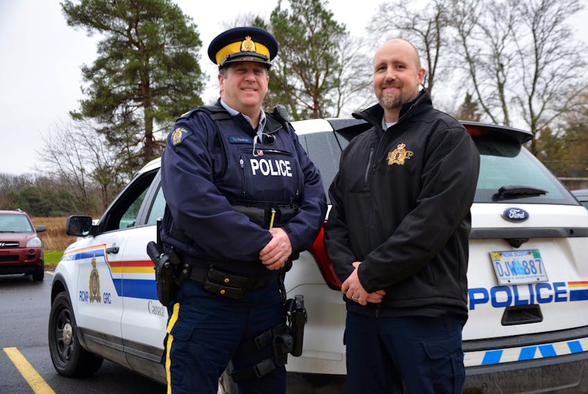 Adam Burns, right, Annapolis District RCMP community programs officer, and Cpl. Tim Hawkes hope to fill the back of this RCMP SUV several times during Cram the Cruiser events planned for Middleton and Bridgetown between now and Christmas.