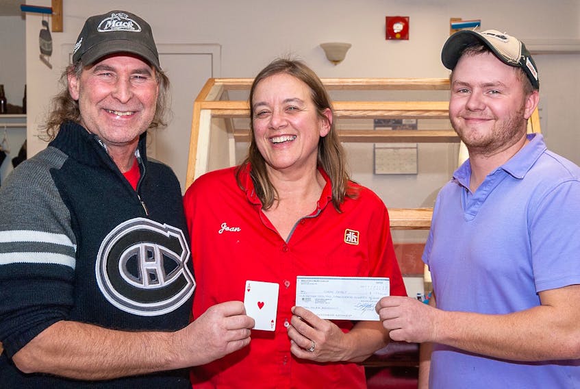Middleton Curling Club’s Cody Spidle hands over a cheque for the total of the night’s Chase the Ace pot plus the value of the Ace -- a total of $19,380.