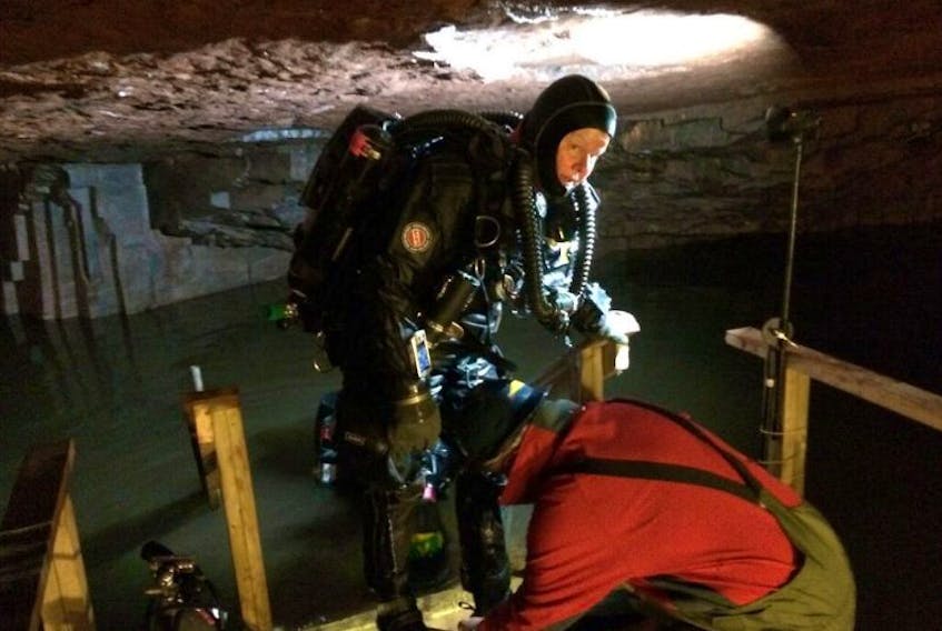 Jill Heinerth, cave diver and filmmaker, coming out of the water deep inside the Bell Island mines.