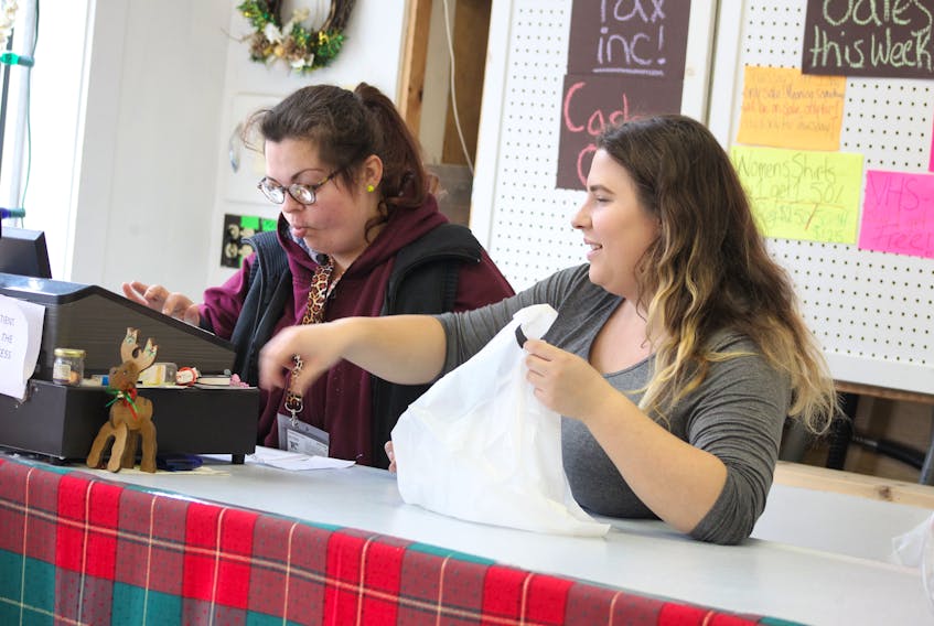 Lawrencetown thrift shop staff members Heidi, left, and Sarah are hard at work in the shop.