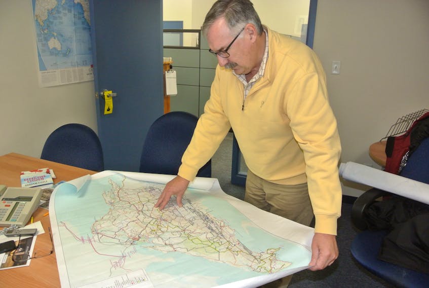Glen Hudson, president of the Cumberland County Riders, looks over a map of the trail system in Cumberland County. His association and others are lobbying the province to change legislation giving them access to roads so they can connect the region’s extensive trail system.