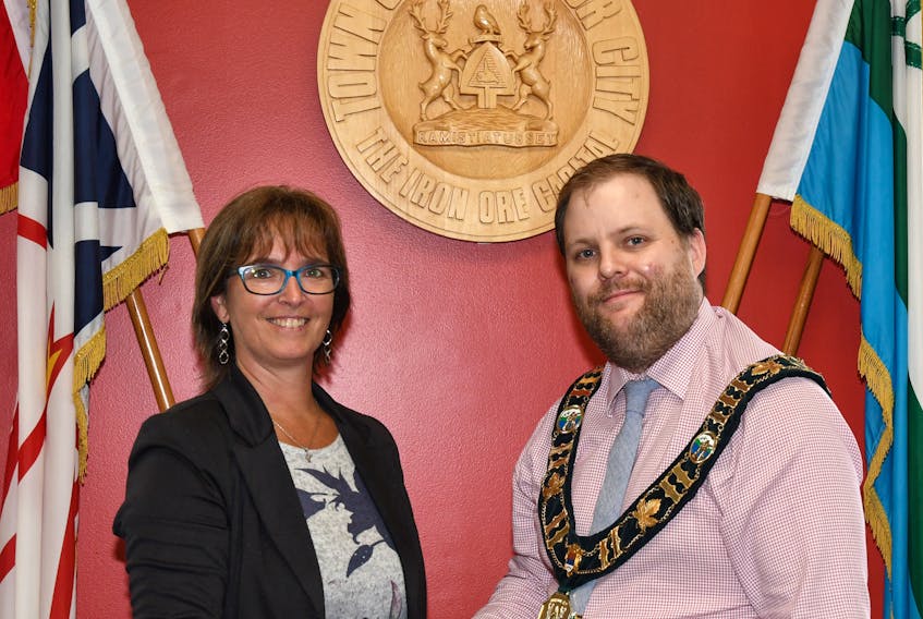 Cathy Etsell, the new Chief Administrative Officer of Labrador City gets a congratulatory handshake from Mayor Wayne Button.