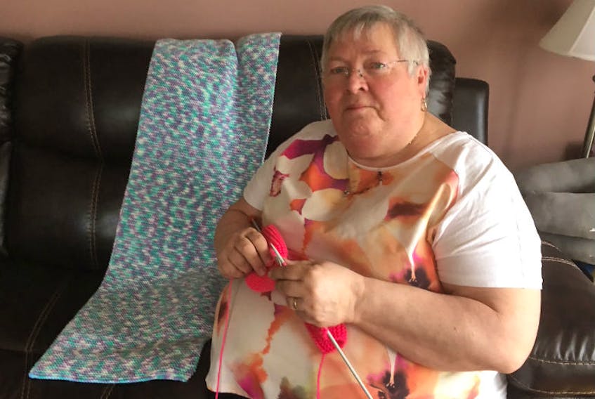 Janet Parsons with one of the prayer shawls she knitted.
