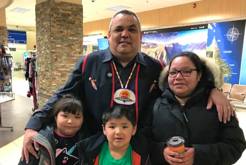 Christine Abraham with her children – seven-year-old MaKayla Rich and six-year-old MacIssac Rich – is pictured with Sheshatshiu Innu First Nation Chief Eugene Hart in a photo taken at Goose Bay airport as Abraham and her children were leaving Labrador for St. John’s