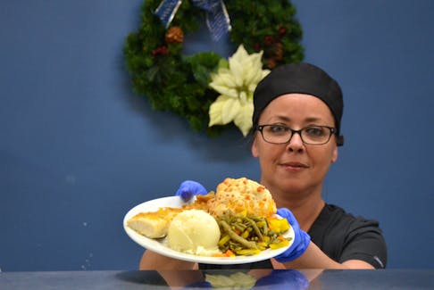 Jennifer Sheridan cooked up haddock, potatoes and vegetables on Dec. 23 at Soldiers’ Memorial Hospital. She’ll be up early on Christmas Day to cook as many as 75 turkey dinners for patients and their families before heading home to have her own Christmas dinner.