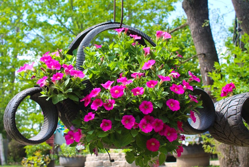 This planter, made out of recycled tires, is one of the handy outdoor items that Santos Treminio creates.