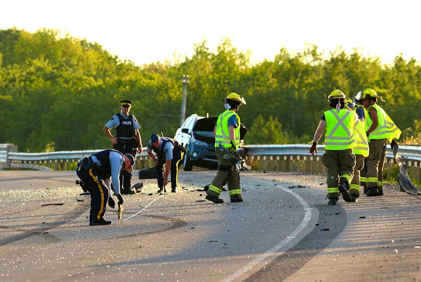 Firefighters helped clear the road of debris as RCMP officers investigated a two-vehicle collision near Exit 11 in Greenwich Aug. 3.
ADRIAN JOHNSTONE