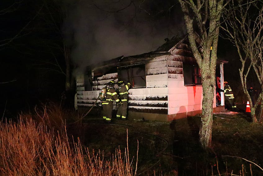 Firefighters were called to a fire at this vacant house on Station Road in Wilmot early Sunday morning, hours after the nearby Kwik-Way convenience store on Highway 1 burned. - Adrian Johnstone