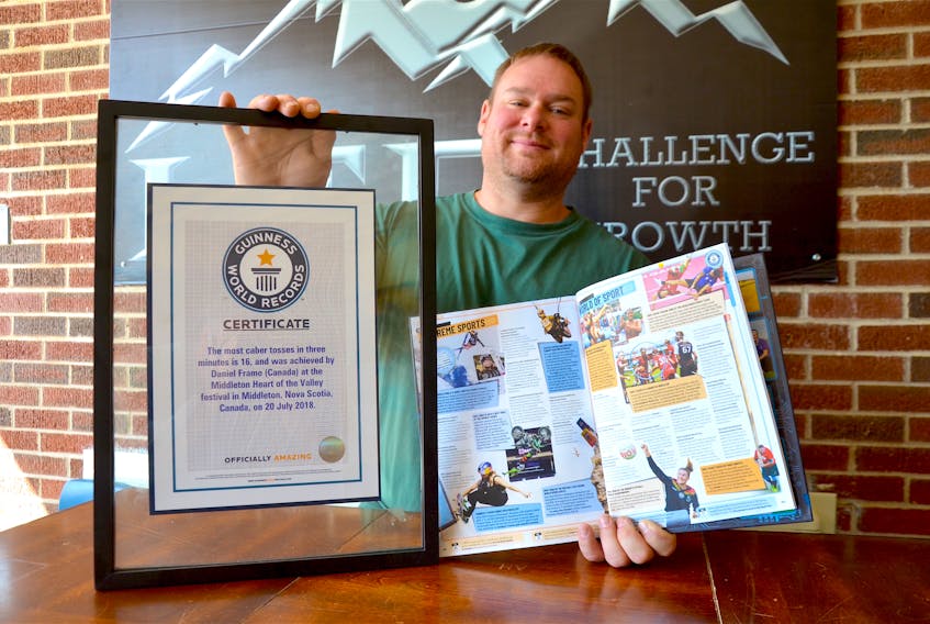 Danny Frame with his Guinness World Record certificate and the just-released 2020 Guinness World Records book. Frame set a caber toss world record in 2018 when he successfully tossed the big spruce pole 16 times in three minutes. LAWRENCE POWELL