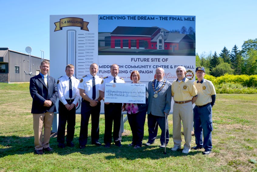 Middleton Fire Chief Mike Toole accepts a cheque for $50,000 from Rotary Club of Middleton president Christine Beck Aug. 28 on the site of the future community centre and fire hall. A fundraising campaign is hoping to raise $1.4 million towards the $3.9-million project. From left are Middleton Councillor and committee co-chair Gary Marshall, fire deputies Jody Spidle and Scott Veinot, Toole, Beck, mayor and committee co-chair Sylvester Atkinson, and Rotarians Al Peppard and Ed Fry.