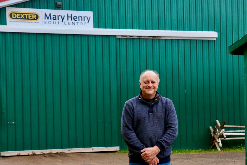 Andy Woolaver stands in front of the Mary Henry Equi-Centre at the Hants County Exhibition Grounds in Windsor. Woolaver moved to the area about 25 years ago as his horse-riding daughters were being taught by Henry.