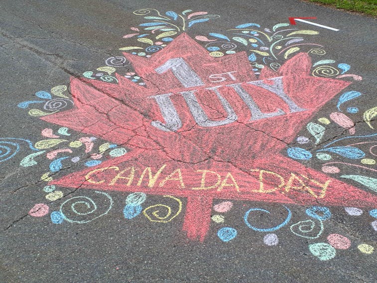 Cathy Dunbar used chalk to help decorate the end of her street in time for Canada Day and her husband, Ian, helped decorate the lawn with flags and whirligigs. The artistic effort paid off as the Dunbars placed first in the HMCC July 1 home decorating competition. CONTRIBUTED